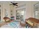 Covered patio area with wicker furniture, an overhead fan and access to the outdoors via sliding glass doors at 6882 Sw 113Th Pl, Ocala, FL 34476