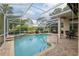 Screened-in pool and spa area with outdoor dining and lush landscaping at 6882 Sw 113Th Pl, Ocala, FL 34476