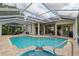 Sparkling screened pool with spa and patio area, perfect for outdoor enjoyment at 6882 Sw 113Th Pl, Ocala, FL 34476