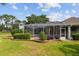 Backyard view of a screened-in pool area with decorative brick-lined landscaping at 6882 Sw 113Th Pl, Ocala, FL 34476