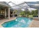Beautiful screened pool with spa, outdoor kitchen, and patio overlooking a lush yard at 6882 Sw 113Th Pl, Ocala, FL 34476