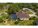 Aerial view of a backyard featuring a screened-in pool, patio, and lush landscaping at 6882 Sw 113Th Pl, Ocala, FL 34476