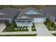 Overhead view of a lovely blue home featuring a manicured lawn and complementary landscaping at 7429 Sw 61St St, Ocala, FL 34474