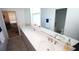 Spacious bathroom featuring double sinks, a large mirror, and ample counter space at 7429 Sw 61St St, Ocala, FL 34474