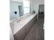 Large bathroom vanity with dual sinks, a large mirror, and plenty of storage space at 7429 Sw 61St St, Ocala, FL 34474