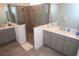 Modern bathroom featuring dual vanities, quartz countertops, and a frameless glass shower enclosure at 7429 Sw 61St St, Ocala, FL 34474