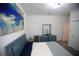 Bright bedroom showcasing modern blue decor, including a bed, dresser, and abstract art at 7429 Sw 61St St, Ocala, FL 34474