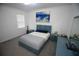 Cozy bedroom with blue furnishings, including a bed, side tables, and dresser at 7429 Sw 61St St, Ocala, FL 34474