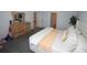 Well-lit main bedroom with a comfortable bed, soft carpet, and a dresser with decorative mirror at 7429 Sw 61St St, Ocala, FL 34474