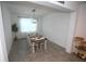 Dining room features a long table with seating for eight, with a modern chandelier at 7429 Sw 61St St, Ocala, FL 34474