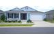 Charming blue home featuring a well-manicured lawn, white rock landscaping, and an attached two-car garage at 7429 Sw 61St St, Ocala, FL 34474