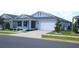 Beautifully landscaped home with a manicured lawn, complementary landscaping, and attached two-car garage at 7429 Sw 61St St, Ocala, FL 34474