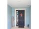 Charming blue front door with white trim, a 'welcome' mat, and a decorative floral wreath at 7429 Sw 61St St, Ocala, FL 34474