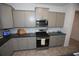 Well-equipped kitchen with stainless steel appliances and gray cabinets at 7429 Sw 61St St, Ocala, FL 34474