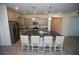 Spacious kitchen with granite countertops, stainless steel appliances, pendant lighting, and seating around the island at 7429 Sw 61St St, Ocala, FL 34474