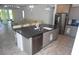Kitchen island featuring dark countertop, stainless steel dishwasher, and sink at 7429 Sw 61St St, Ocala, FL 34474