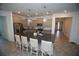 Open-concept kitchen featuring granite countertops, stainless steel appliances, pendant lighting, and an island with seating at 7429 Sw 61St St, Ocala, FL 34474