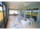 Spacious screened lanai with comfortable seating, ceiling fans, and views of a manicured outdoor space at 7429 Sw 61St St, Ocala, FL 34474