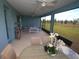 Relaxing screened lanai with comfortable seating, ceiling fans, outdoor dining, and a peaceful view at 7429 Sw 61St St, Ocala, FL 34474