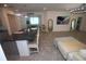 Open concept living space featuring a breakfast bar, tile floors, and modern decor at 7429 Sw 61St St, Ocala, FL 34474