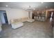 Open-concept living room with a large sectional sofa, tile flooring, and kitchen view with breakfast bar at 7429 Sw 61St St, Ocala, FL 34474