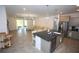 Open concept living space with a kitchen island and comfortable seating at 7429 Sw 61St St, Ocala, FL 34474