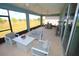 Relaxing screened patio with comfortable seating, ceiling fans, and an outdoor dining area with a beautiful view at 7429 Sw 61St St, Ocala, FL 34474