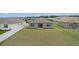 View of backyard with expansive green space, privacy fence, and sliding glass doors leading into the home at 7571 Sw 64Th Street Rd, Ocala, FL 34474