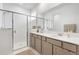 Bright bathroom featuring a double sink vanity, glass-enclosed shower, and contemporary fixtures at 7571 Sw 64Th Street Rd, Ocala, FL 34474
