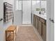 Modern bathroom features double sinks, framed mirrors, glass-enclosed shower, and neutral color scheme at 7571 Sw 64Th Street Rd, Ocala, FL 34474