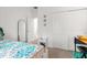 Bright bedroom with a patterned bed, white closet doors, and a functional desk area at 7571 Sw 64Th Street Rd, Ocala, FL 34474