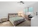 Inviting bedroom features a comfortable bed, a ceiling fan, and a cozy window-side workspace at 7571 Sw 64Th Street Rd, Ocala, FL 34474