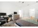 Well-lit bedroom features desk, dresser, TV, and a comfortable bed, perfect for relaxation and productivity at 7571 Sw 64Th Street Rd, Ocala, FL 34474