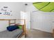 Bright bedroom features a twin bed, storage space, and a whimsical 'Trust in the Lord' wall decal at 7571 Sw 64Th Street Rd, Ocala, FL 34474