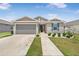 Charming single-story home with neutral exterior, two-car garage, and neatly manicured landscaping at 7571 Sw 64Th Street Rd, Ocala, FL 34474