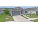 Beautiful single-story home with a well-kept lawn, a two-car garage, and tidy landscaping at 7571 Sw 64Th Street Rd, Ocala, FL 34474