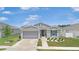 Charming single-story home with a gray exterior, well-maintained landscaping, and a two-car garage at 7571 Sw 64Th Street Rd, Ocala, FL 34474