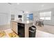 Open kitchen with an island, stainless steel appliances and an adjacent dining area, perfect for gatherings at 7571 Sw 64Th Street Rd, Ocala, FL 34474