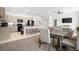 Open floor plan with kitchen featuring granite counters and bar seating overlooking the living area at 7571 Sw 64Th Street Rd, Ocala, FL 34474