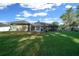 Spacious backyard with a screened lanai perfect for outdoor living, plus a well-kept lawn and mature trees at 811 Se 49Th Ave, Ocala, FL 34471