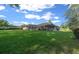 Expansive backyard featuring a well-maintained lawn, screened-in porch, and views of lush greenery at 811 Se 49Th Ave, Ocala, FL 34471