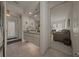 Neutral bathroom with tile floors, spacious countertop, and an inviting view into the living area at 811 Se 49Th Ave, Ocala, FL 34471
