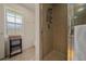 Bathroom shower area with a window for natural light and neutral tile at 811 Se 49Th Ave, Ocala, FL 34471