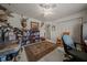 Comfortable bedroom with a ceiling fan, a rocking chair, and a large rug on the floor at 811 Se 49Th Ave, Ocala, FL 34471