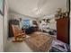 Spacious bedroom with a ceiling fan, a rocking chair, and a large rug on the floor at 811 Se 49Th Ave, Ocala, FL 34471