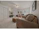 Bedroom with neutral color palette, ceiling fan, carpet, and a cozy seating area at 811 Se 49Th Ave, Ocala, FL 34471