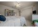 Bright bedroom offers a ceiling fan, soft carpet, and comfortable neutral decor at 811 Se 49Th Ave, Ocala, FL 34471