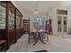 A formal dining room features a chandelier, custom cabinetry, and plantation shutters for natural light at 811 Se 49Th Ave, Ocala, FL 34471
