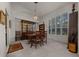 This dining room features a chandelier, plantation shutters, and a table set for six at 811 Se 49Th Ave, Ocala, FL 34471