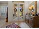 A welcoming foyer features tile flooring, a decorative rug, and elegant double doors leading to the outside at 811 Se 49Th Ave, Ocala, FL 34471